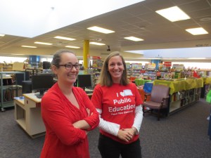 Volunteers wearing red are ready to help in the library!